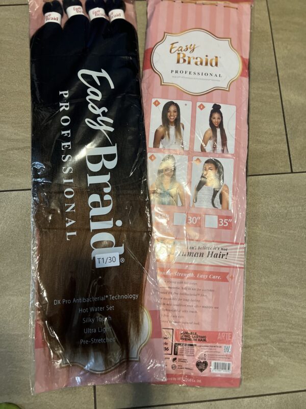 A package of hair extensions on the floor.