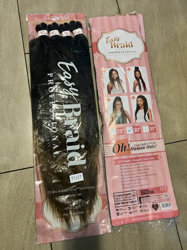 A package of hair extensions is shown on the floor.