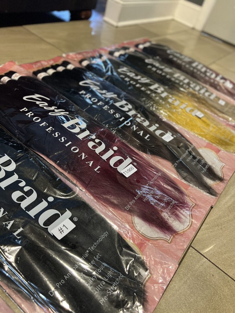 A bunch of different colored hair extensions in packages.